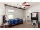 Cozy bedroom features a ceiling fan, closet, and warm carpeting at 20709 W Delaney Dr, Buckeye, AZ 85396
