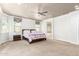 Spacious primary bedroom featuring a ceiling fan, plush carpet, and neutral color palette at 20709 W Delaney Dr, Buckeye, AZ 85396