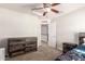 Well-lit bedroom with rustic wood furniture, ceiling fan, and neutral carpeting at 20709 W Delaney Dr, Buckeye, AZ 85396