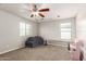 Bright bonus room featuring a ceiling fan, neutral tones, and versatile space at 20709 W Delaney Dr, Buckeye, AZ 85396