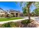 Charming home with two-car garage, covered porch, desert landscaping, lush green lawn, and long driveway at 20709 W Delaney Dr, Buckeye, AZ 85396
