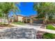 Charming two-story home with two-car garage, desert landscaping, lush green lawn, and long driveway at 20709 W Delaney Dr, Buckeye, AZ 85396