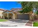 Charming two-story home with two-car garage, desert landscaping, lush green lawn, and a covered porch at 20709 W Delaney Dr, Buckeye, AZ 85396