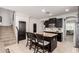 Gourmet kitchen featuring dark cabinets, a center island, and an adjacent staircase at 20709 W Delaney Dr, Buckeye, AZ 85396