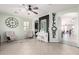 Bright living room with tiled floors, modern ceiling fan, comfortable chairs, and natural light at 20709 W Delaney Dr, Buckeye, AZ 85396