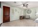 Spacious living room with tiled floors, soft green walls, modern ceiling fan, and natural light at 20709 W Delaney Dr, Buckeye, AZ 85396