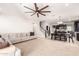 Open-concept living area with a sofa, carpet flooring and view of the kitchen at 20709 W Delaney Dr, Buckeye, AZ 85396