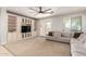Spacious living room with built-in shelving, carpet flooring and a large window at 20709 W Delaney Dr, Buckeye, AZ 85396