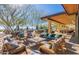 Inviting outdoor seating area with shade, tables, and mountain views at 20709 W Delaney Dr, Buckeye, AZ 85396