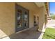 Back patio with an outdoor grill, pillars, and double doors with access to the house at 20709 W Delaney Dr, Buckeye, AZ 85396