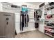 Organized walk-in closet with custom shelving, clothing racks, and safe at 20709 W Delaney Dr, Buckeye, AZ 85396