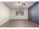 Large bedroom with luxury vinyl flooring, modern ceiling fan, and a bright window at 2146 W Isabella Ave # 131, Mesa, AZ 85202