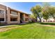 Charming condo building with well-maintained lawn and lush landscaping at 2146 W Isabella Ave # 131, Mesa, AZ 85202