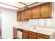 The kitchen features wood cabinets, neutral counters, and a sink overlooking the dining area at 2146 W Isabella Ave # 131, Mesa, AZ 85202