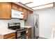 Kitchen with stainless steel appliances, light wood cabinets and neutral counters at 2146 W Isabella Ave # 131, Mesa, AZ 85202