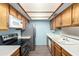 Efficient kitchen featuring stainless steel appliances, and ample wooden cabinets at 2146 W Isabella Ave # 131, Mesa, AZ 85202