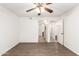 Living room with wood floors, a ceiling fan, and access to the bathroom and additional spaces at 2146 W Isabella Ave # 131, Mesa, AZ 85202