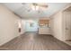 Living room with wood-look flooring, fan, and view into the kitchen at 2146 W Isabella Ave # 131, Mesa, AZ 85202