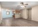 Open living room with wood-look flooring and view of the kitchen area at 2146 W Isabella Ave # 131, Mesa, AZ 85202