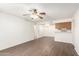 Open-concept living space with wood floors, ceiling fan, and a view of the kitchen at 2146 W Isabella Ave # 131, Mesa, AZ 85202