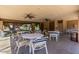 Clubhouse patio with tables, chairs, and ceiling fans at 2146 W Isabella Ave # 131, Mesa, AZ 85202