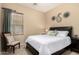 Comfortable bedroom features a king-size bed, modern decor, and great natural lighting at 21563 N Greenway Rd, Maricopa, AZ 85138