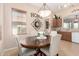 Inviting dining area with a wood table, upholstered chairs, decorative lighting, and neutral wall colors at 21563 N Greenway Rd, Maricopa, AZ 85138