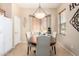 Comfortable dining area showcasing a wood table, upholstered chairs, a window seat, and tiled floors at 21563 N Greenway Rd, Maricopa, AZ 85138
