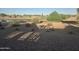Scenic golf course view with a tranquil pond, lush trees, and distant golfers enjoying the sunny day at 21563 N Greenway Rd, Maricopa, AZ 85138
