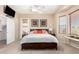 Bright main bedroom with a ceiling fan, carpet, and access to a patio at 21563 N Greenway Rd, Maricopa, AZ 85138