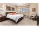 Warm main bedroom with a bay window, ceiling fan, and neutral carpet at 21563 N Greenway Rd, Maricopa, AZ 85138