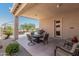 Spacious covered outdoor patio with comfortable seating and a beautiful view of the surroundings at 21563 N Greenway Rd, Maricopa, AZ 85138