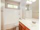 Bright bathroom featuring a bathtub-shower combo and a vanity sink at 2401 W Ellis St, Phoenix, AZ 85041