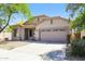 Single-story home with a two-car garage and well-maintained landscaping adding to its curb appeal at 2401 W Ellis St, Phoenix, AZ 85041