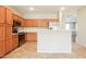 Functional kitchen featuring stainless steel appliances, a breakfast bar, and tiled flooring at 2401 W Ellis St, Phoenix, AZ 85041
