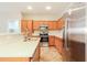 Well-lit kitchen with stainless steel appliances, ample cabinetry, and a breakfast bar at 2401 W Ellis St, Phoenix, AZ 85041