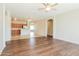 Open-concept living room with hardwood floors, a ceiling fan, and seamless access to the kitchen at 2401 W Ellis St, Phoenix, AZ 85041