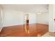 Bright living room featuring hardwood floors, neutral walls, and an open layout to the kitchen at 2401 W Ellis St, Phoenix, AZ 85041