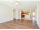 Open-concept living room with hardwood floors, a ceiling fan, and seamless access to the kitchen at 2401 W Ellis St, Phoenix, AZ 85041