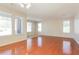 Spacious living room with large windows, hardwood floors, and neutral tones at 2401 W Ellis St, Phoenix, AZ 85041