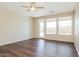 Bright living room with hardwood floors, large windows, and a door to the backyard at 2401 W Ellis St, Phoenix, AZ 85041