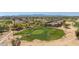 Aerial view of a golf course community with houses and scenic mountain views in the distance at 2406 N 142Nd Ave, Goodyear, AZ 85395