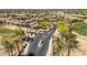 Scenic aerial view of homes in a golf course community with lush landscaping and mature palm trees at 2406 N 142Nd Ave, Goodyear, AZ 85395