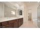 Bright bathroom with dual sinks, a large mirror, and a separate tub and shower, offering a spa-like experience at 2406 N 142Nd Ave, Goodyear, AZ 85395