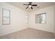 Bright bedroom with multiple windows providing plenty of natural light, and a ceiling fan for added comfort at 2406 N 142Nd Ave, Goodyear, AZ 85395