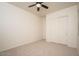 Cozy bedroom with a ceiling fan and closet, creating a comfortable and organized living space at 2406 N 142Nd Ave, Goodyear, AZ 85395