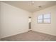 Serene bedroom featuring plush carpet, neutral walls, a window, and access to a balcony for a tranquil retreat at 2406 N 142Nd Ave, Goodyear, AZ 85395