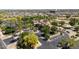 Aerial view of a beautiful clubhouse, surrounded by palm trees, with parking and a playground nearby at 2406 N 142Nd Ave, Goodyear, AZ 85395