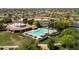 Aerial view of a pristine community pool area, complete with ample seating and shade structures at 2406 N 142Nd Ave, Goodyear, AZ 85395