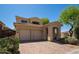 Beautiful two-story home with a three-car garage, mature landscaping, and a brick driveway at 2406 N 142Nd Ave, Goodyear, AZ 85395